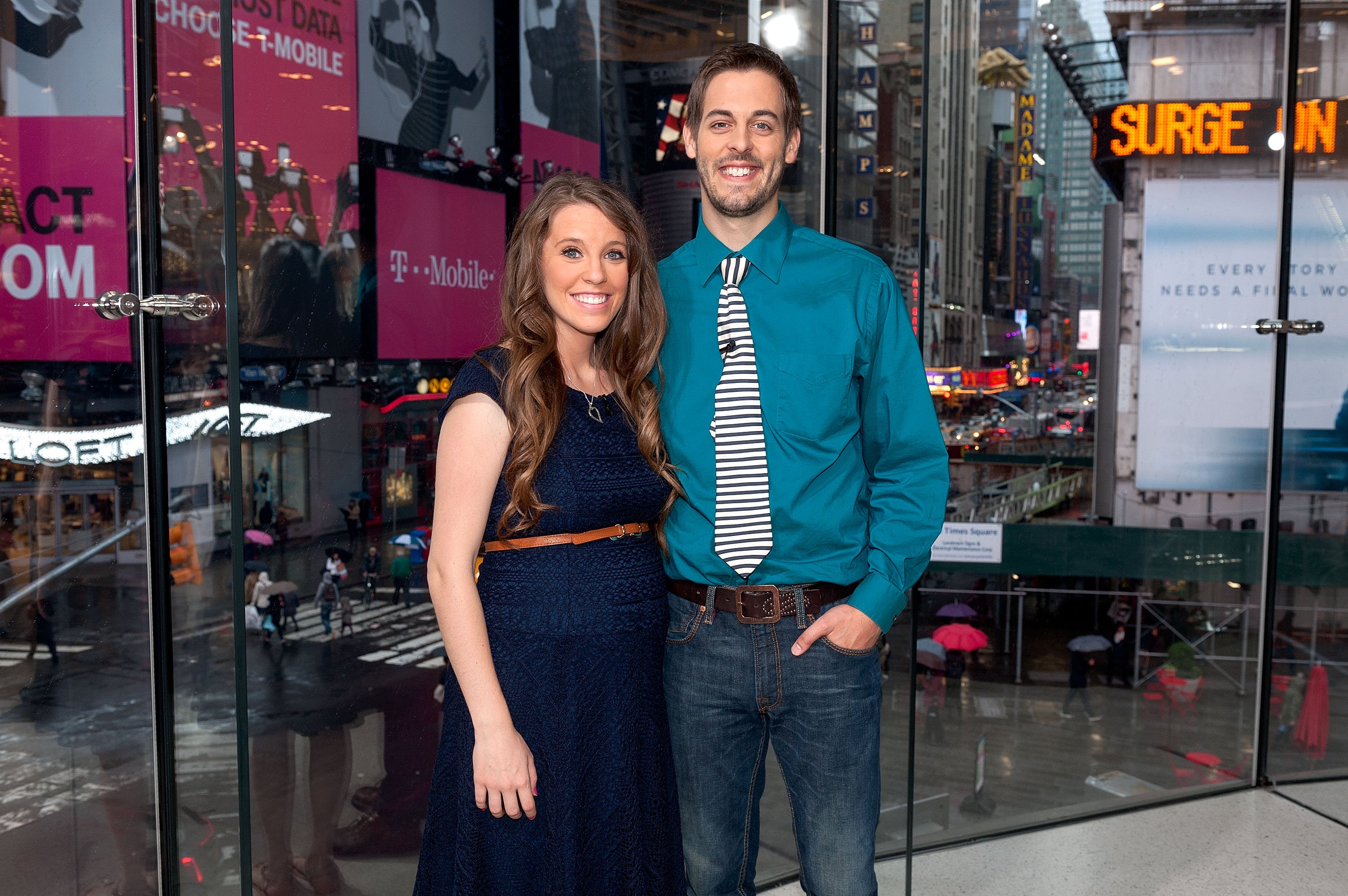 Jill Dillard and Derick Dillard pose for a photo while visiting the set of 'Extra'