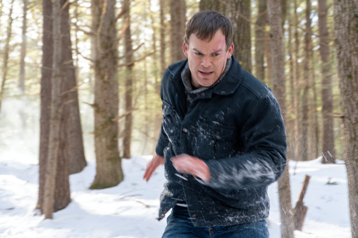 Michael C. Hall as Dexter in Dexter: New Blood Episode 8. Dexter runs through the snowy woods.