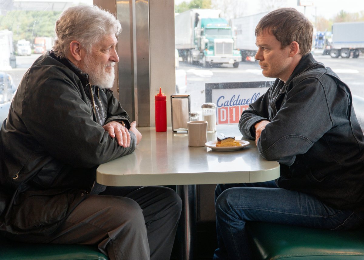Clancy Brown as Kurt and Michael C. Hall as Dexter in Dexter: New Blood. Kurt and Dexter sit across the table from each other at Kurt's diner.