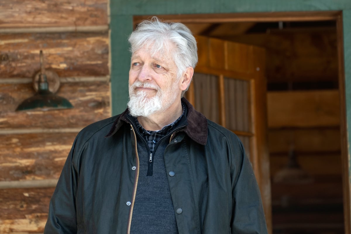 Clancy Brown dresses as Kurt Caldwell in a black shirt and matching jacket