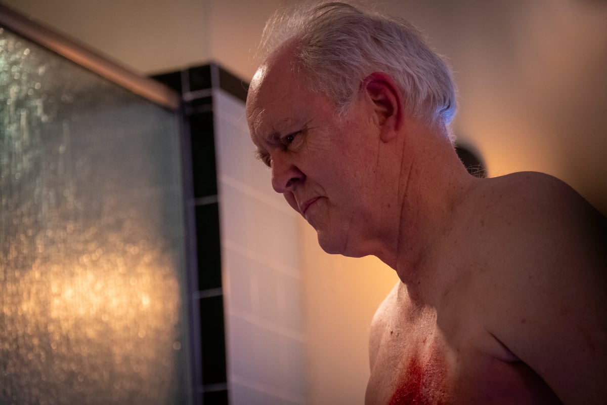 John Lithgow as Arthur Miller (Trinity) in Dexter: New Blood. Trinity is standing naked with blood on his chest.
