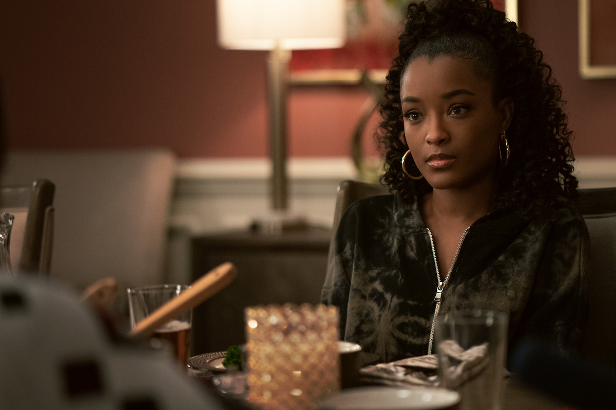 LaToya Tonodeo as Diana Tejada wearing a black jacket at the dinner table in 'Power Book II: Ghost'