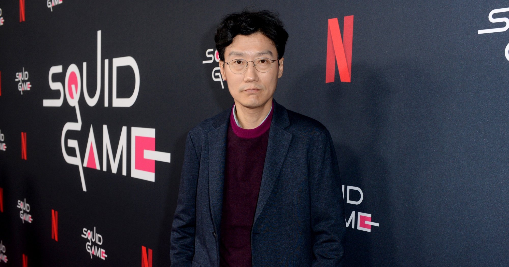 Director Hwang Dong-hyuk of 'Squid Game' K-drama wearing a suit jacket in relation to MrBeast video.