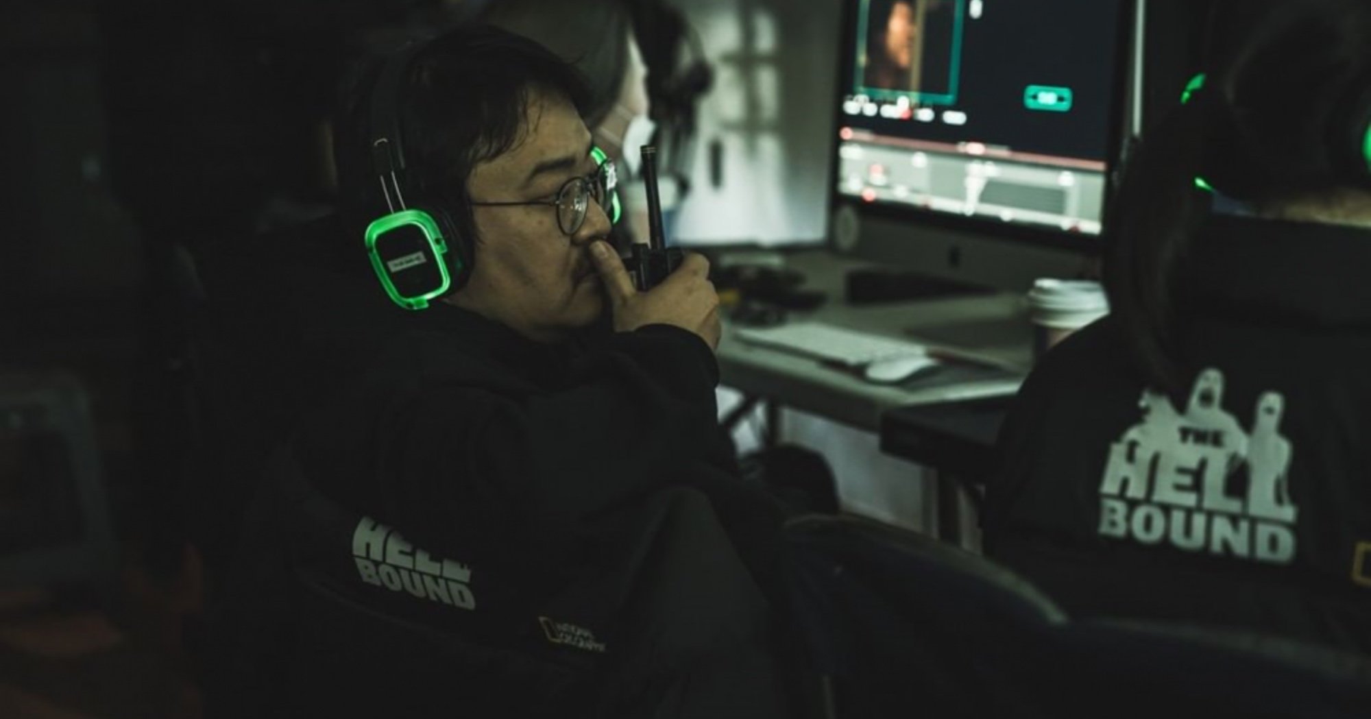 Director Yeon Sang-ho for 'Hellbound' Season 2 Netflix talking on walkie talkie.
