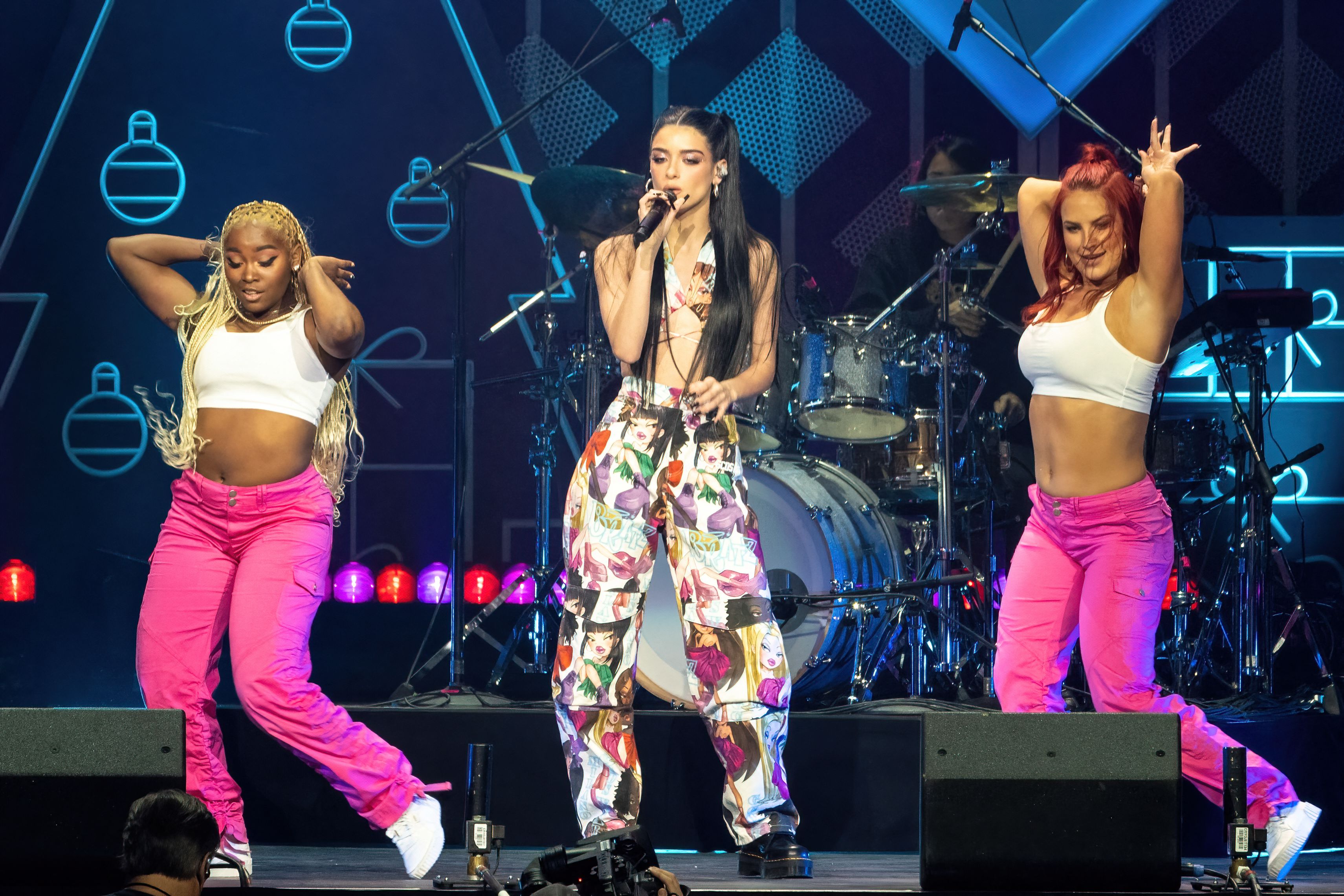 Dixie D'Amelio performs in concert during iHeartRadio 106.1 KISS FM's Jingle Ball 2021 with colorful pants and two backup dancers