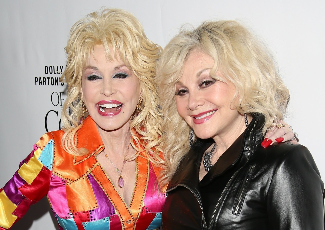 Dolly Parton wears a multi-colored jacket and Stella Parton wears a black leather jacket.