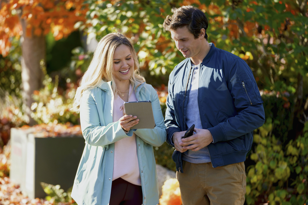 Emilie Ullerup and Clayton James looking at a letter in the Hallmark movie 'Don't Forget I Love You' 