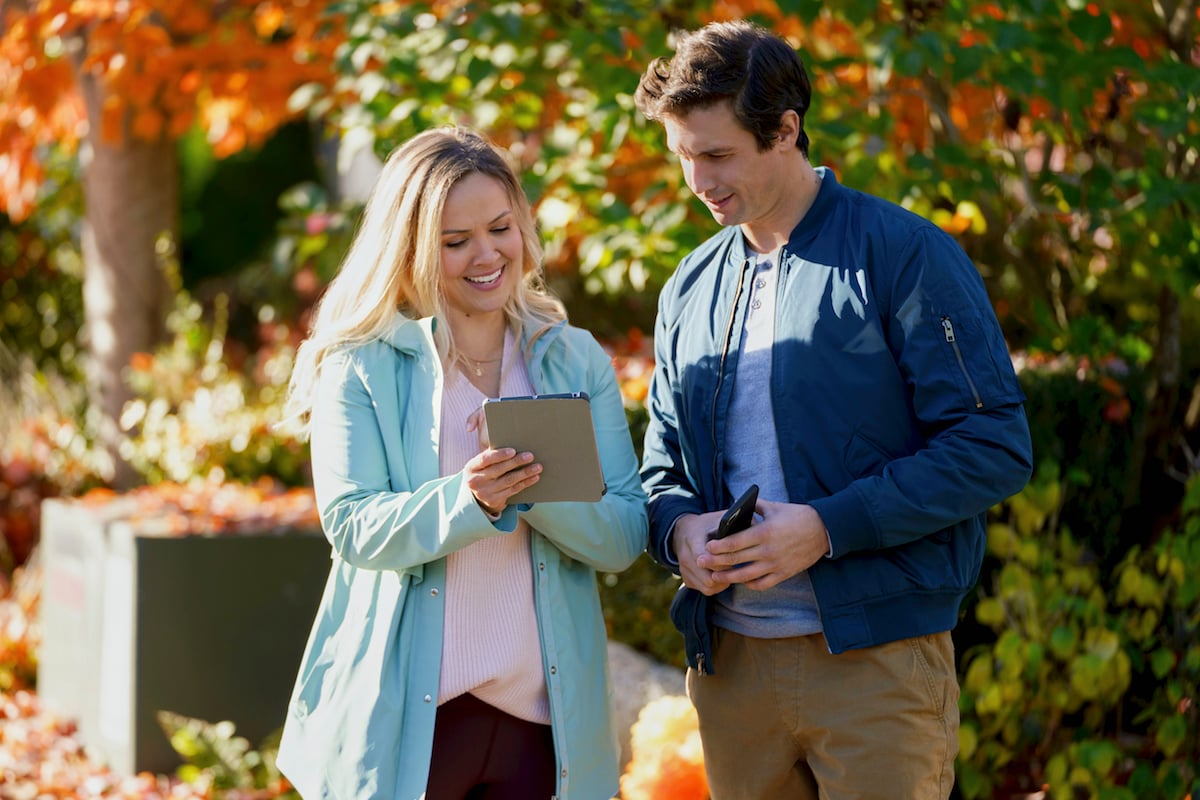 Emilie Ullerup and Clayton James looking at a letter in the Hallmark movie 'Don't Forget I Love You' 