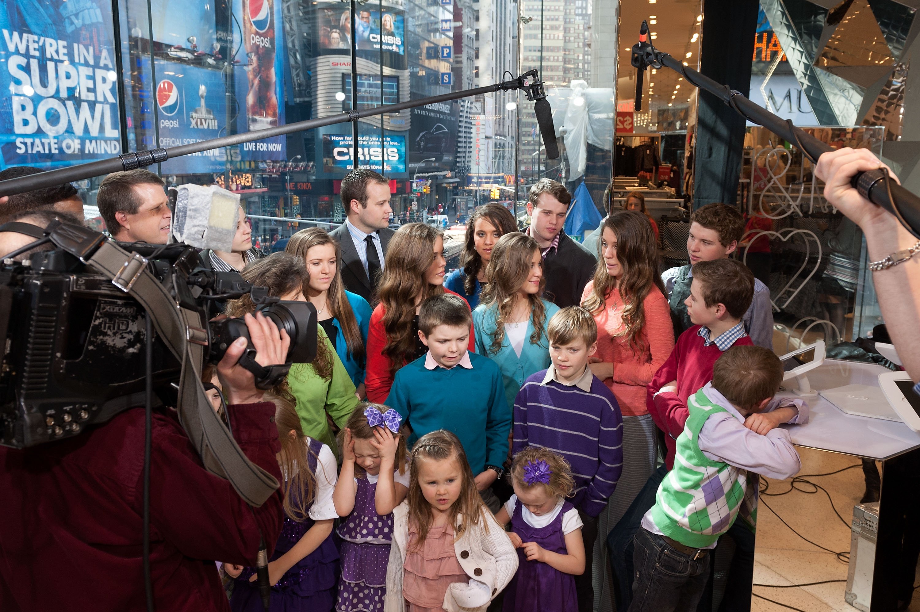 The Duggar famly waits on the set of 'Extra' during one of their visits