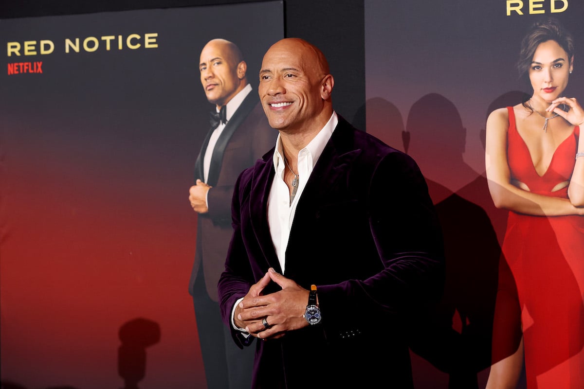 Dwayne Johnson smiles for cameras at the world premiere Of Netflix's 'Red Notice'