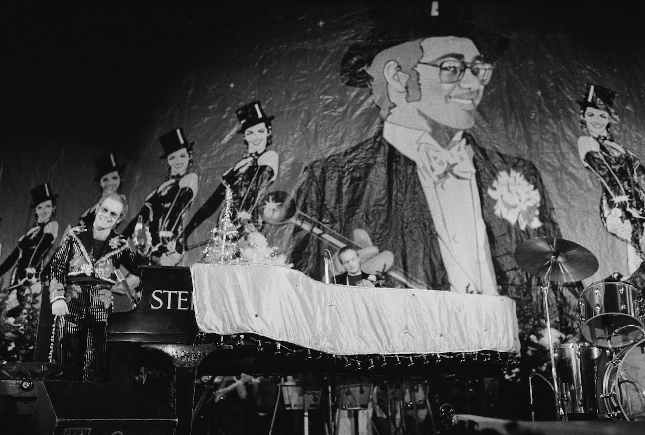 Elton John performing on stage during his Christmas show in London, 1973.
