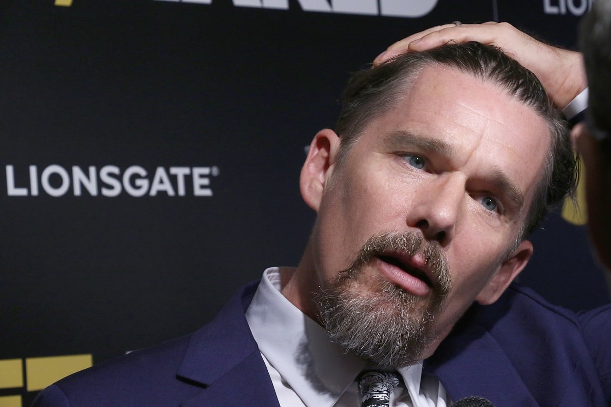 Ethan Hawke rubbing his hair back.