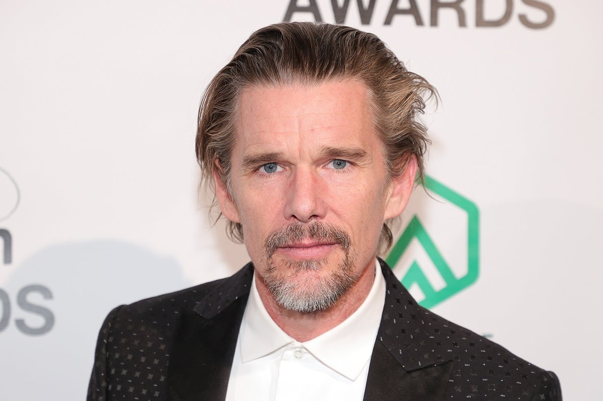 Ethan Hawke posing in a suit.
