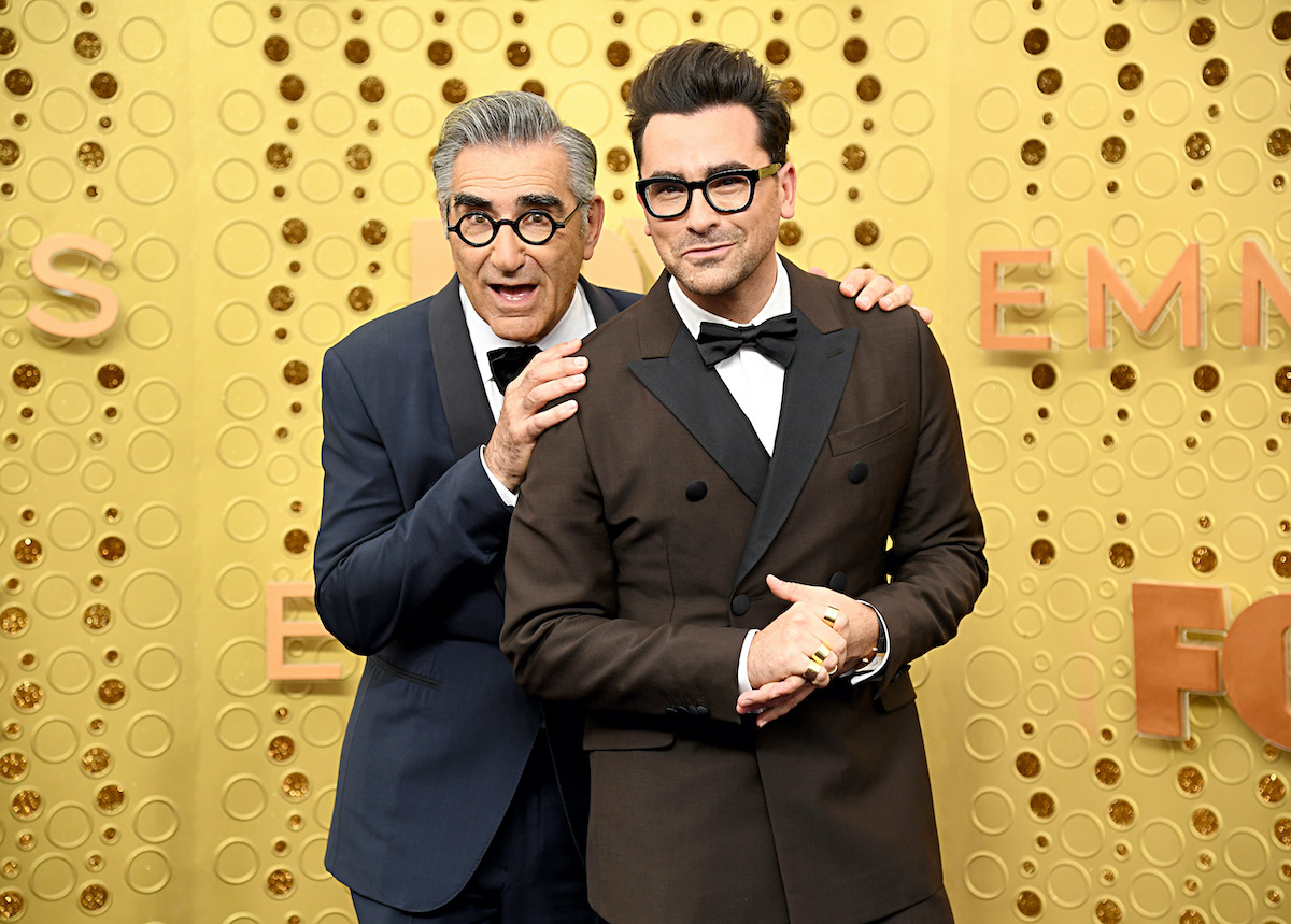 Schitt's Creek co-creators Eugene Levy and Dan Levy walk the red carpet in suits at the Emmys
