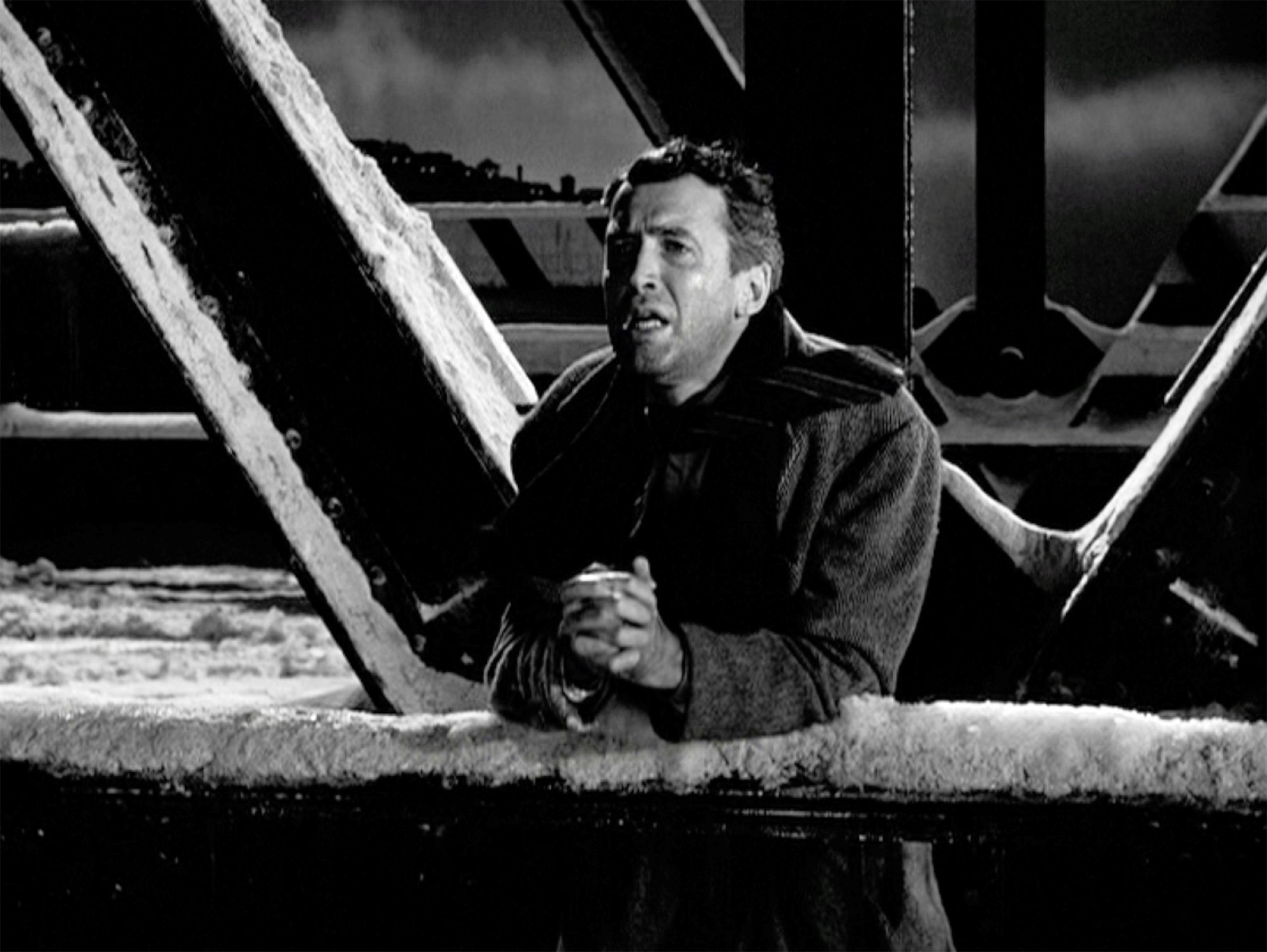 Frank Capra's 'It's a Wonderful Life' James Stewart as George Bailey clasping his hands on the bridge