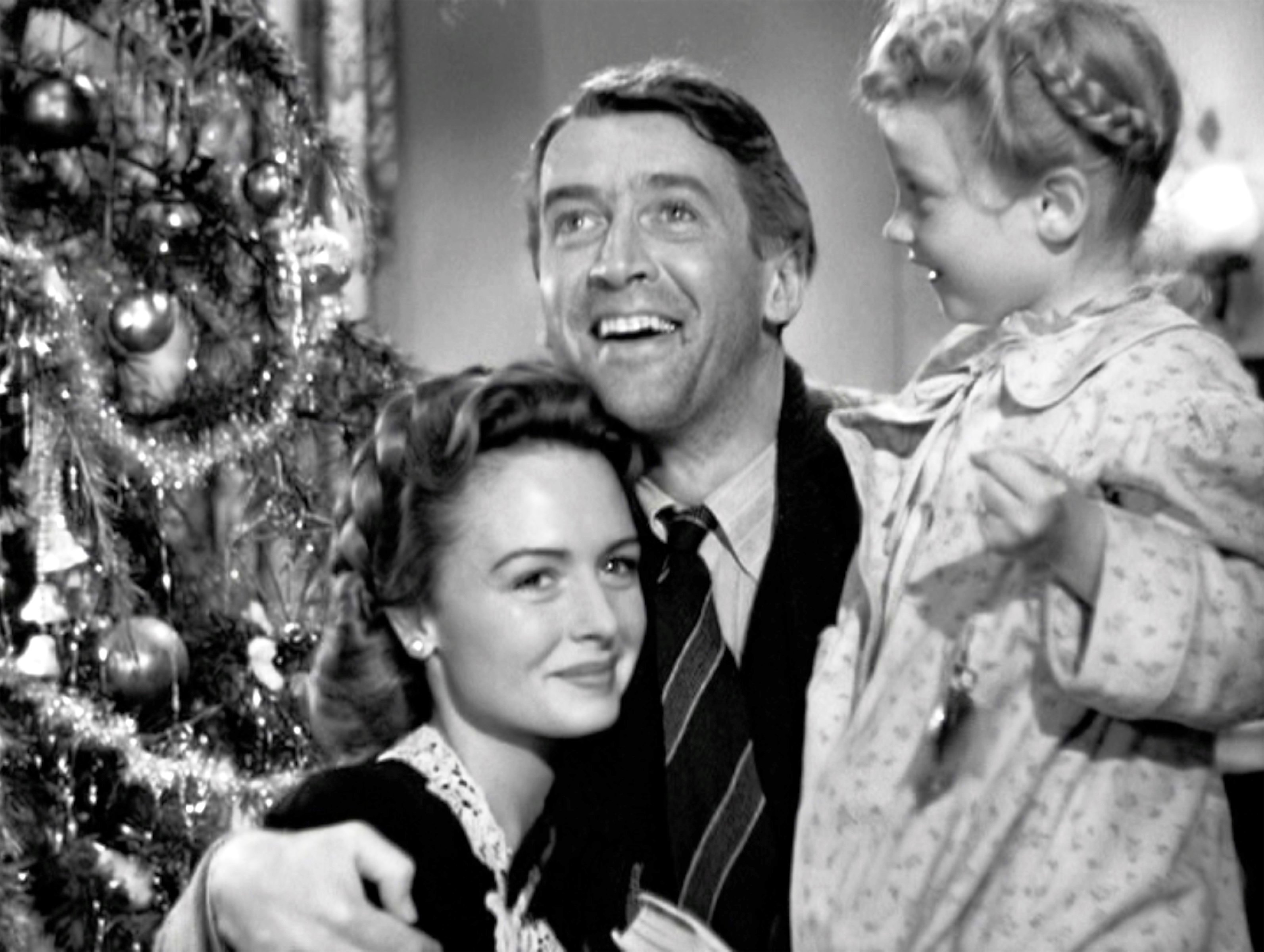George Bailey surrounded by his wife and children at the end of 'It's a Wonderful Life'