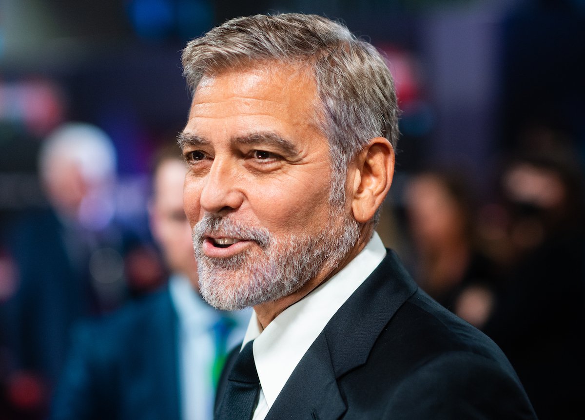 George Clooney poses for cameras during a 2021 movie premiere