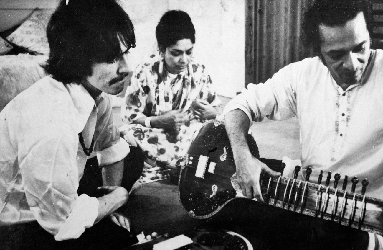 George Harrison and Ravi Shankar playing Indian music on the sitar in 1967.