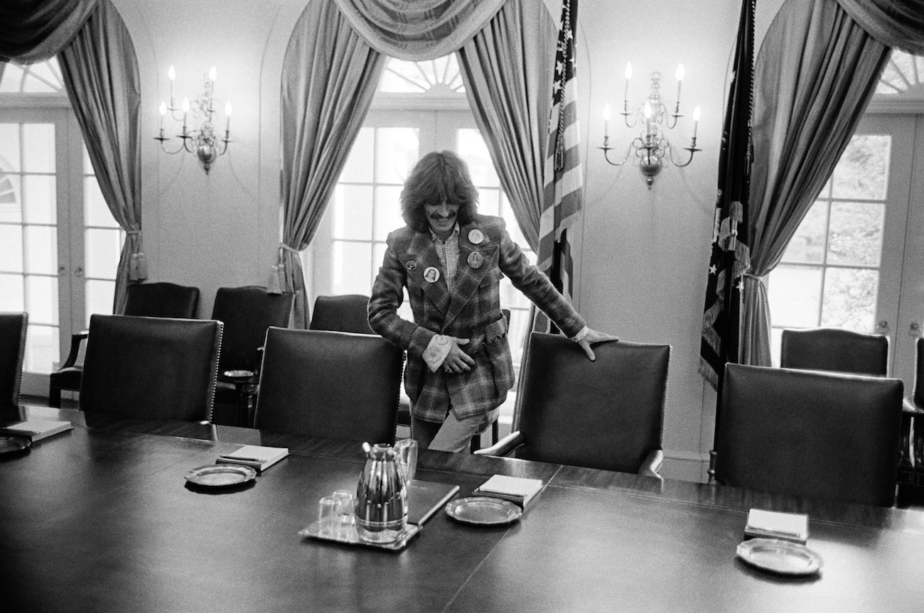 George Harrison sitting in the President's chair in the Cabinet Room of the White House, 1974.