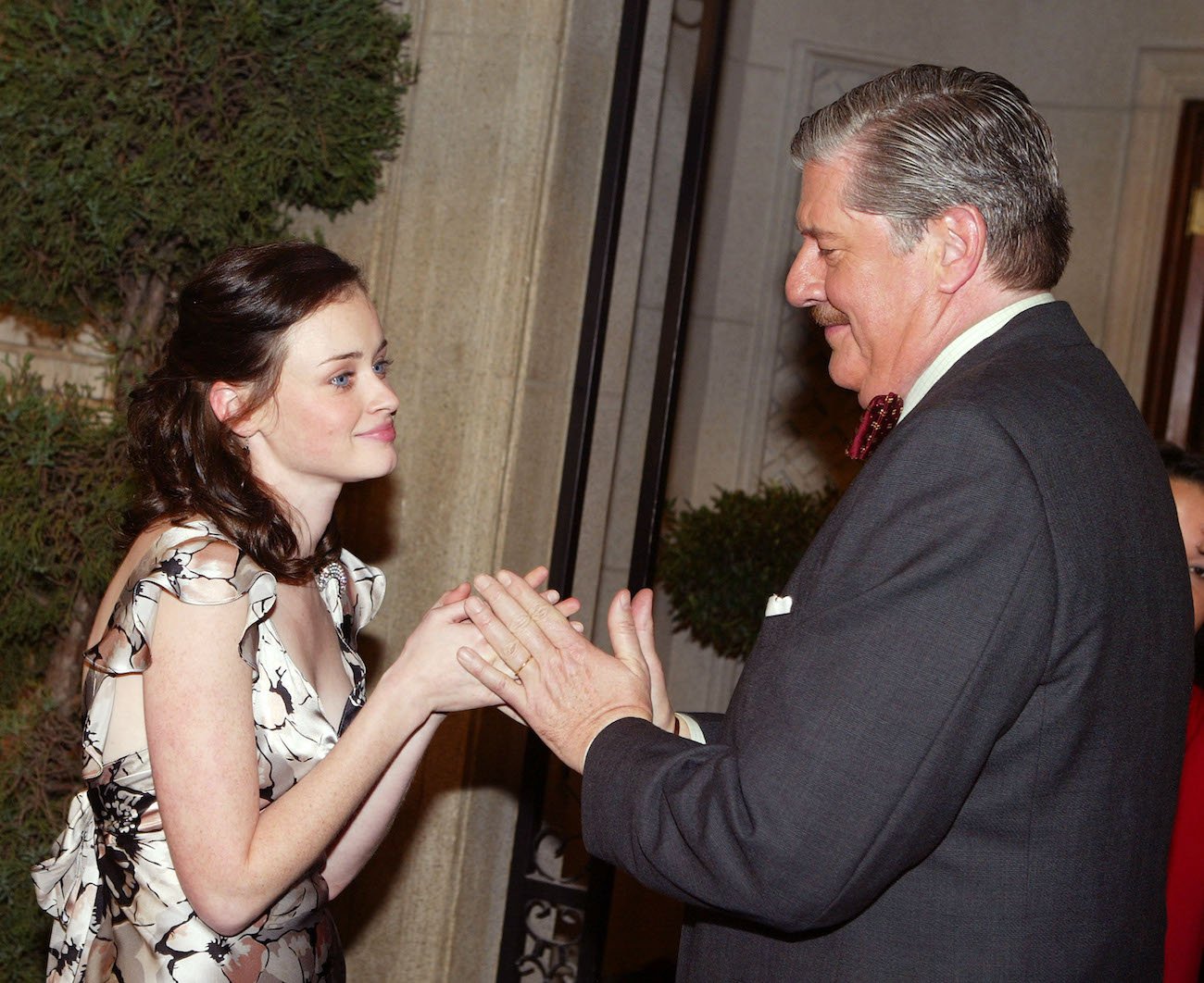 Alexis Bledel and Edward Herrmann look on as they touch hands