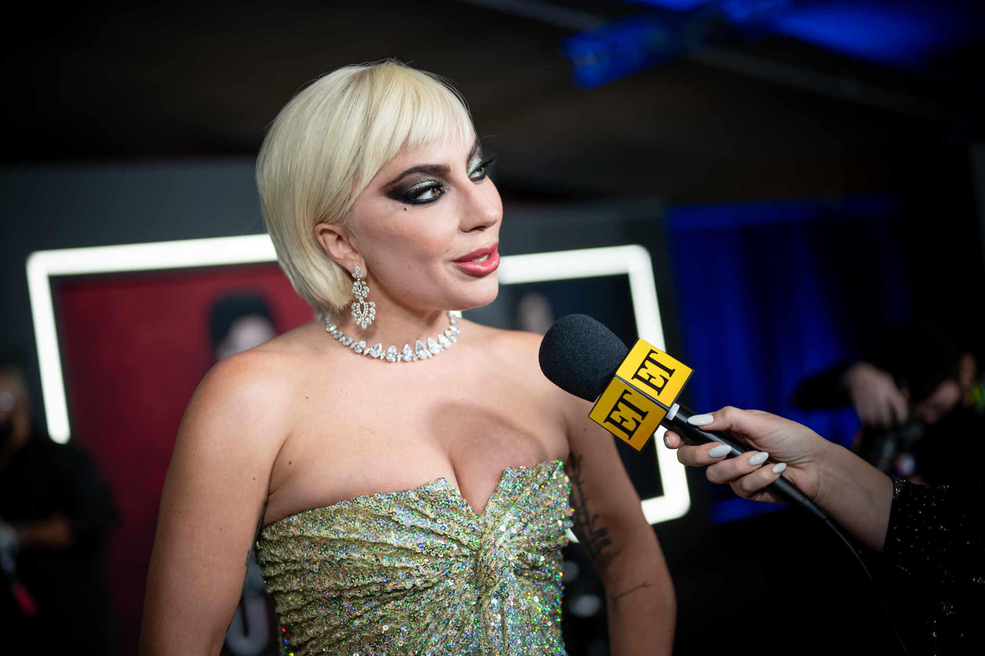'House of Gucci' Lady Gaga speaking into a microphone