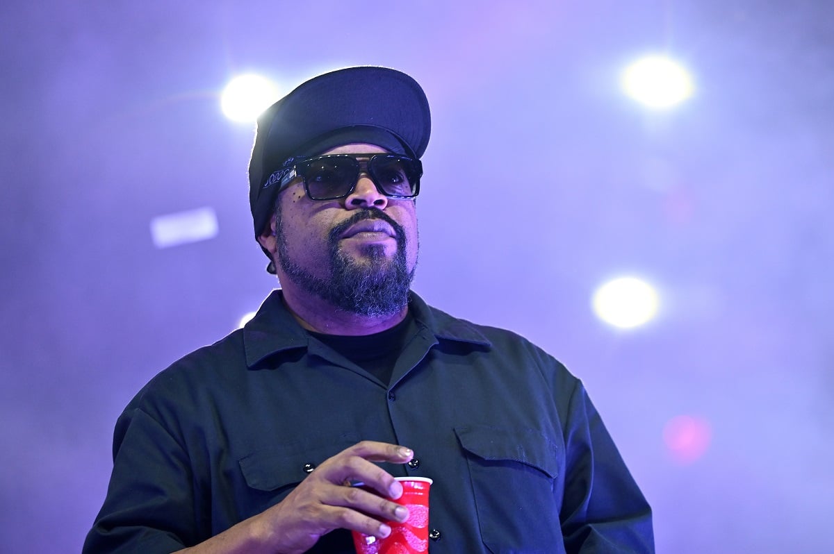 Ice Cube wearing sunglasses while holding a cup.