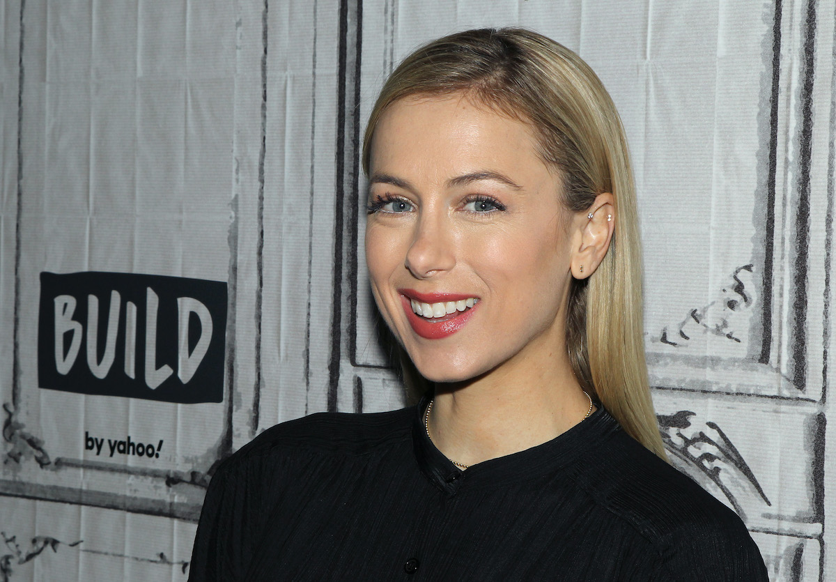 Iliza Shlesinger smiling in front of a white background