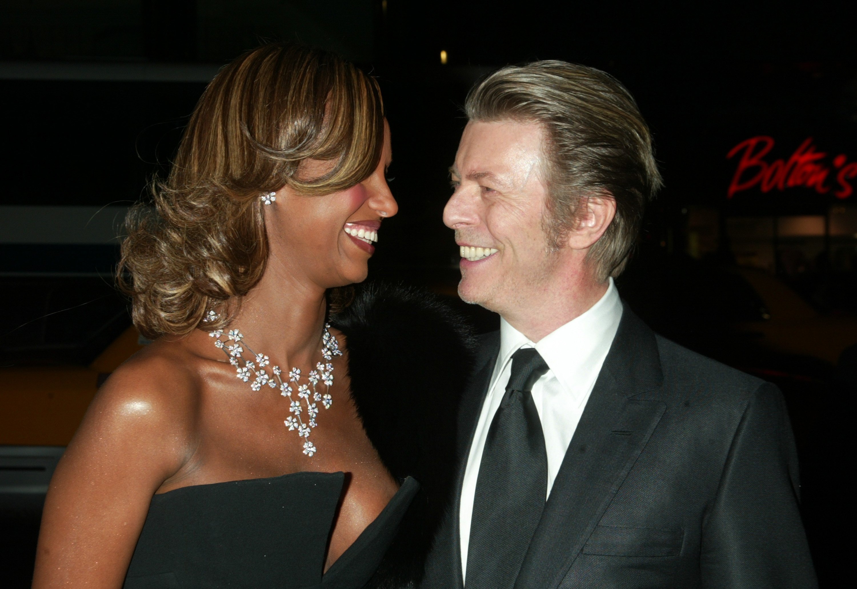 Iman and David Bowie smiling at each other