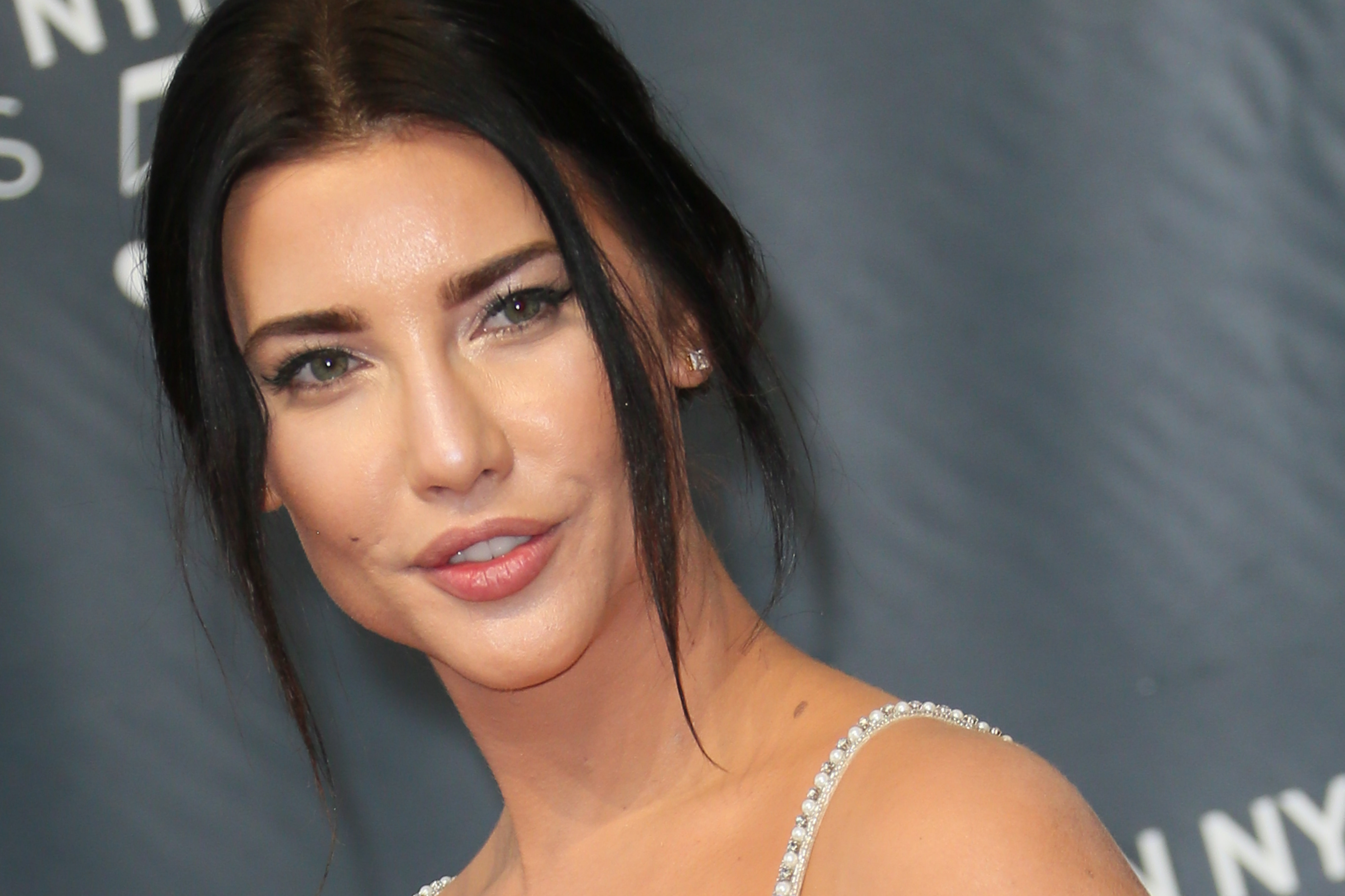 'The Bold and the Beautiful' actor Jacqueline MacInnes Wood wearing a white dress and smiling.