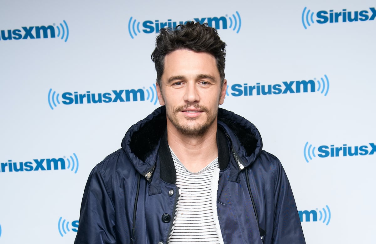 James Franco smiling in front of a white background