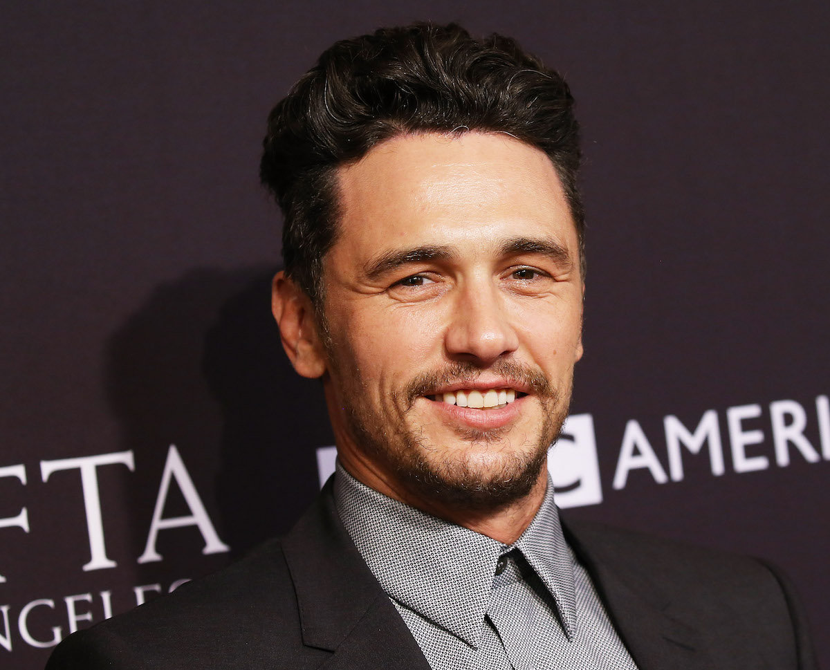 James Franco smiles at an event.