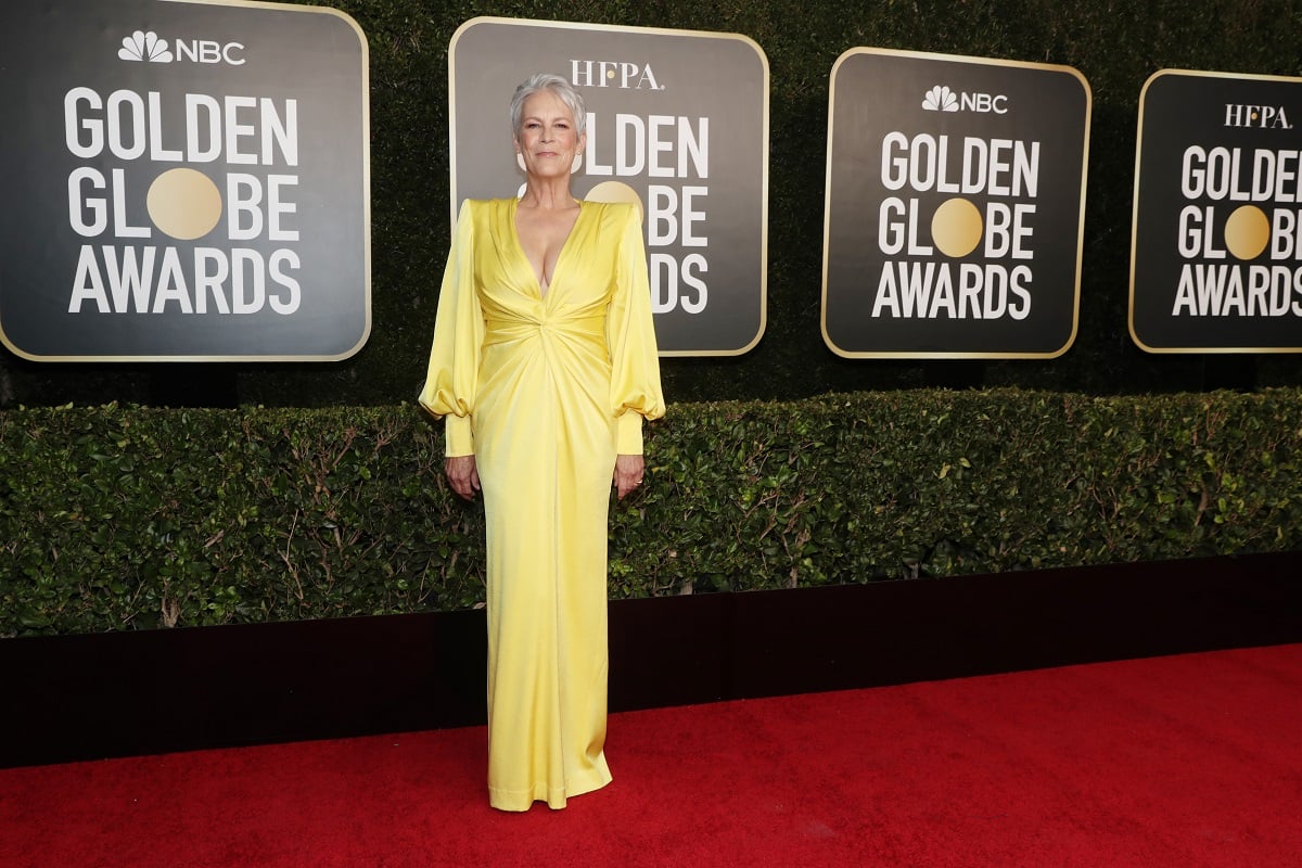 Jamie Lee Curtis smiling in a yellow dress.
