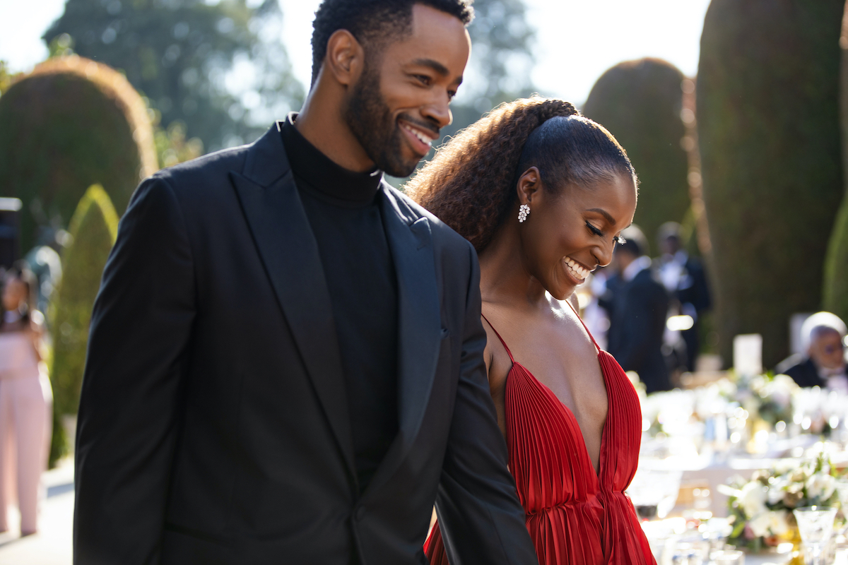 Jay Ellis wearing a black suit and Issa Rae sporting an all red dress in 'Insecure' Season 5.