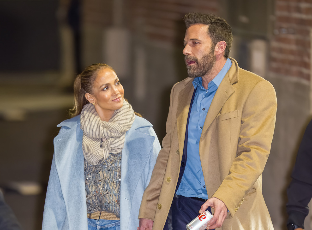 Jennifer Lopez looks at Ben Affleck as they hold hands