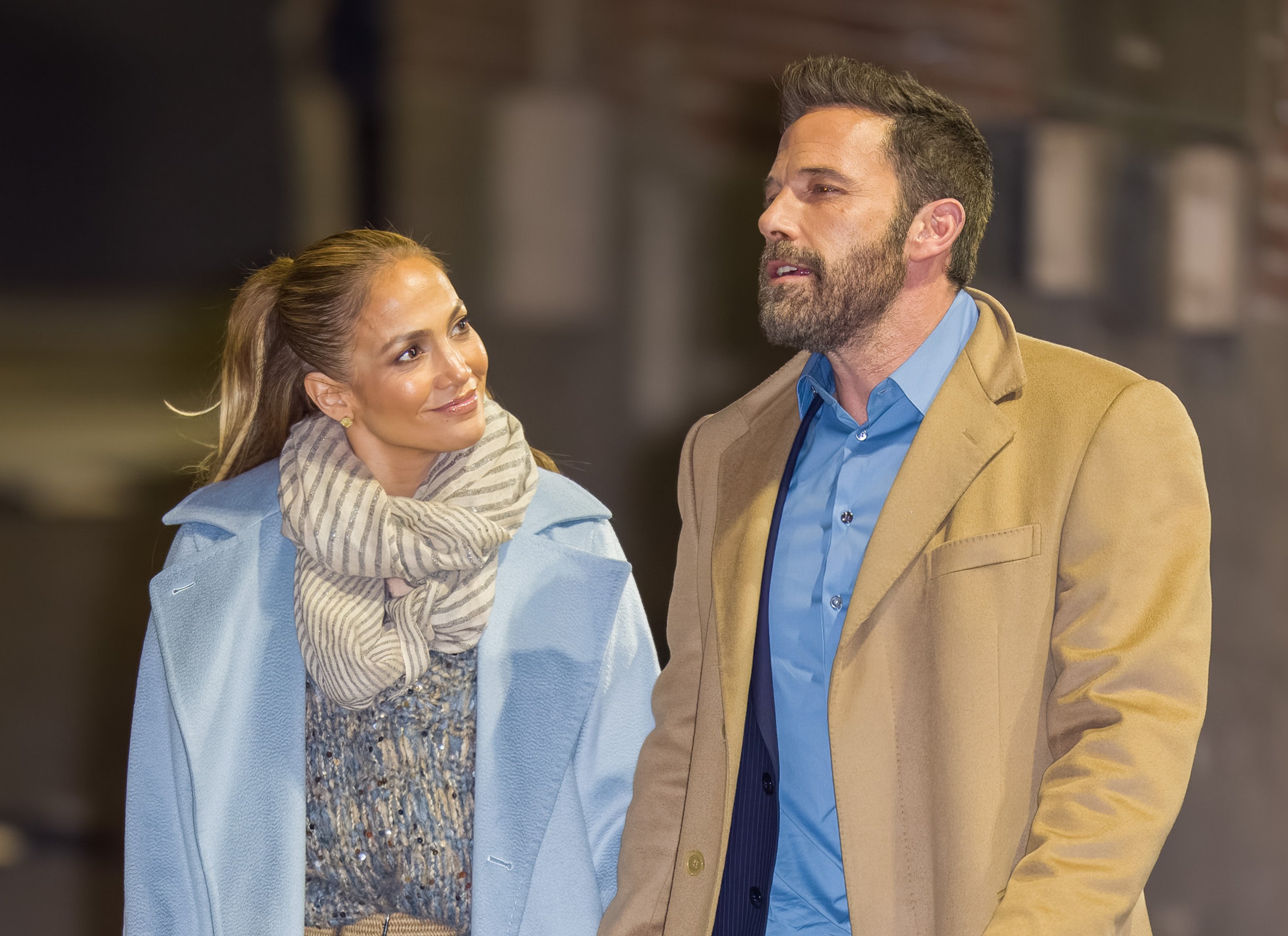 Jennifer Lopez looks at Ben Affleck as they hold hands and walk down the street.