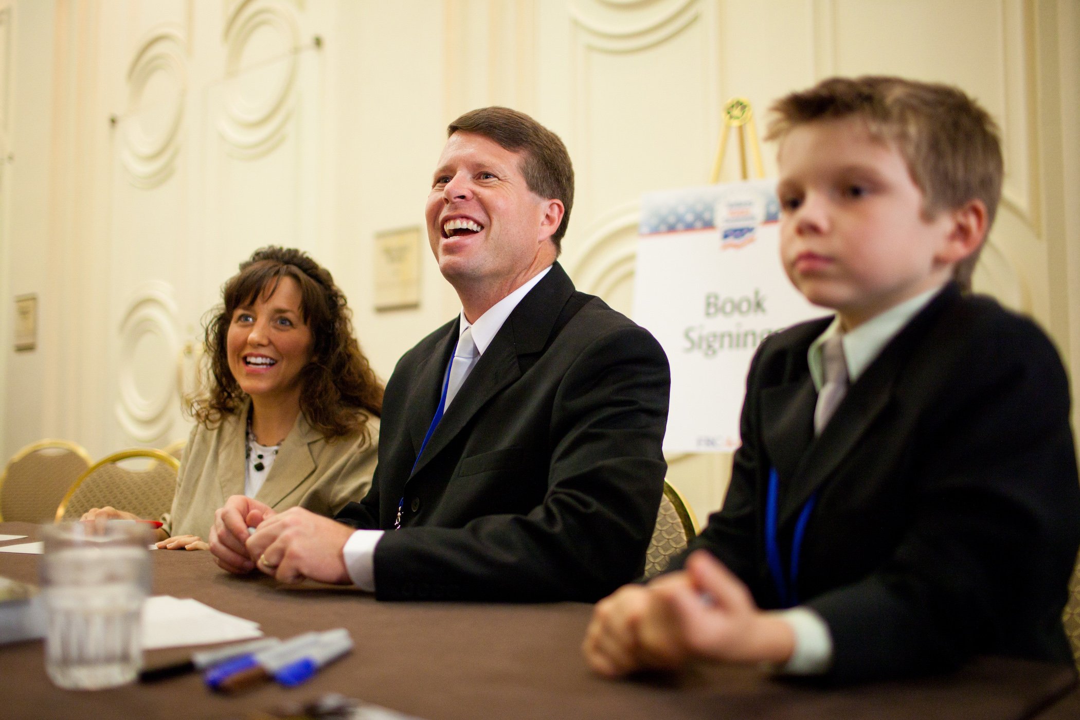 Michelle and Jim Bob Duggar laughing at an event. Jim Bob Duggar testified prior to Josh Duggar's trial.