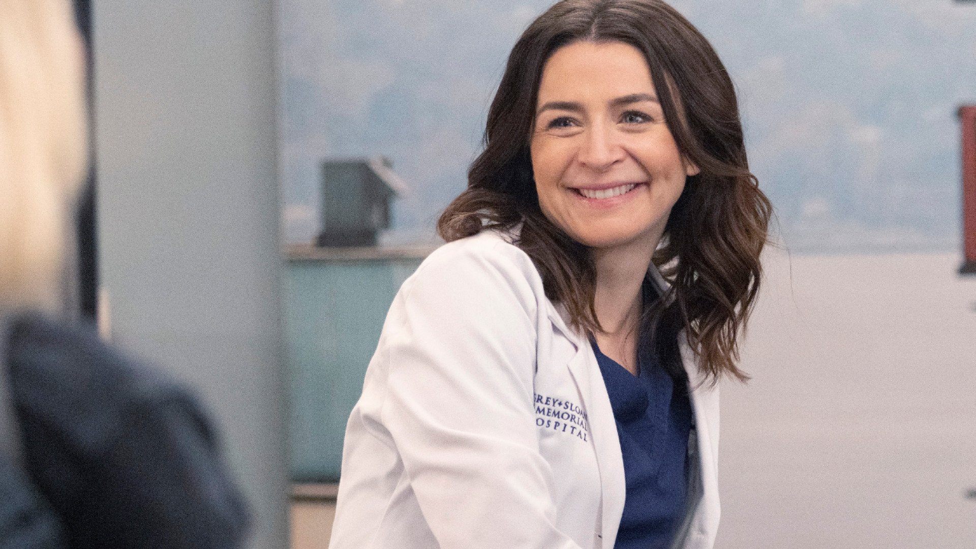 Caterina Scorsone as Amelia Shepherd smiles at Camilla Luddington as Jo Wilson in ‘Grey’s Anatomy’ Season 18 Episode 8, the winter finale