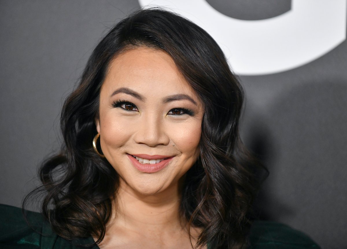 Jona Xiao smiling in front of a black background