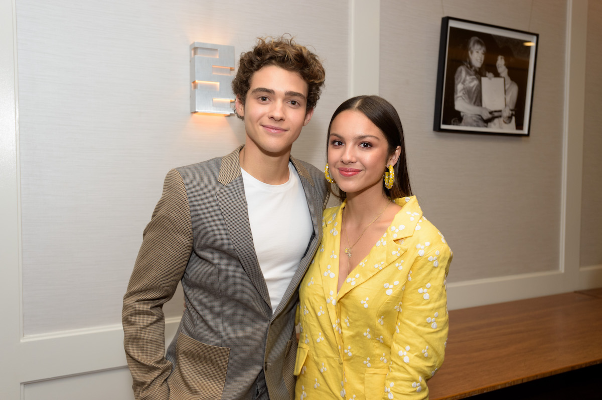 Joshua Bassett and Olivia Rodrigo smile and pose together.