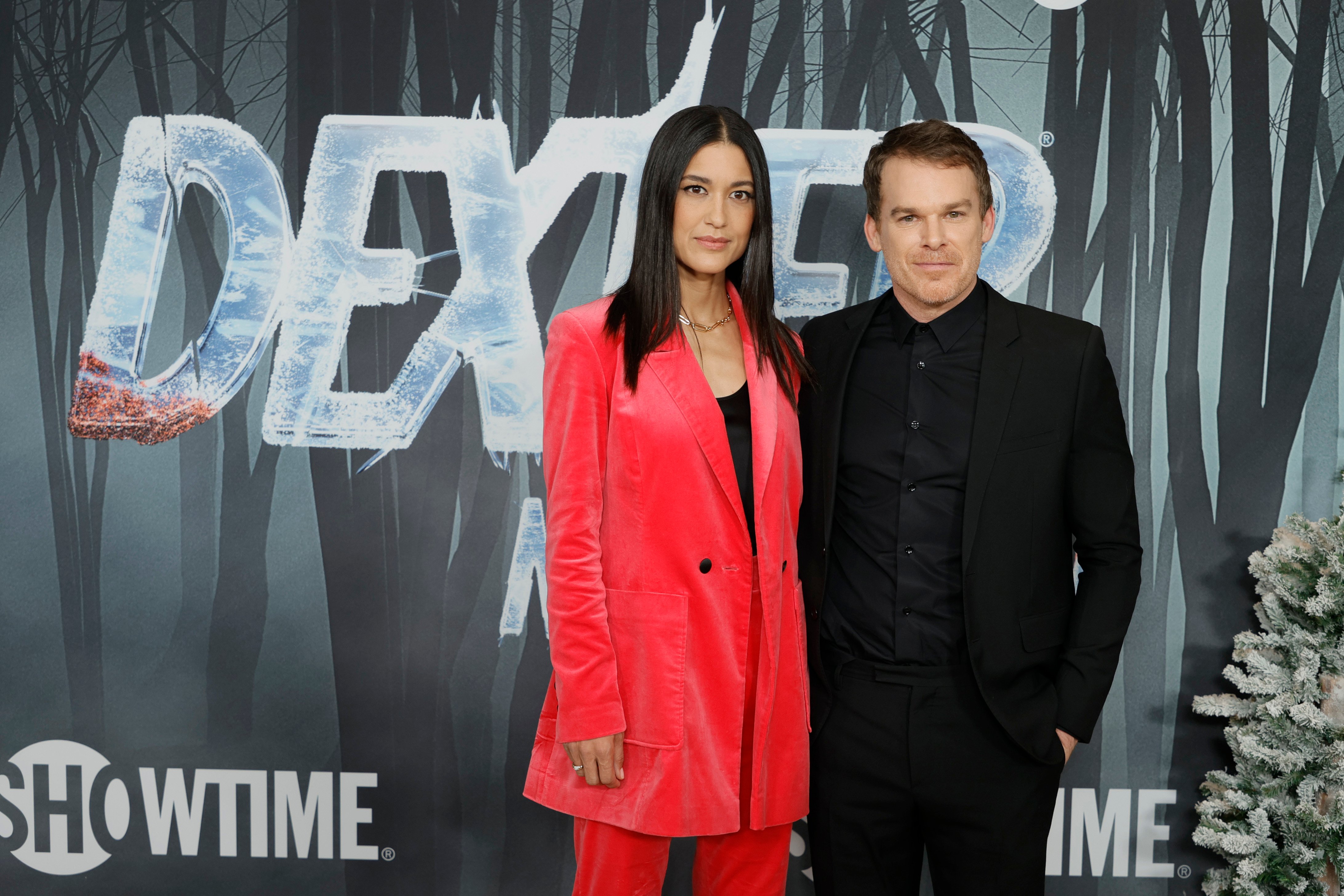 Julia Jones and Michael C. Hall attend the world premiere of Dexter: New Blood Series at Alice Tully Hall. Hall is wearing all black and Jones is wearing a salmon-colored outfit.