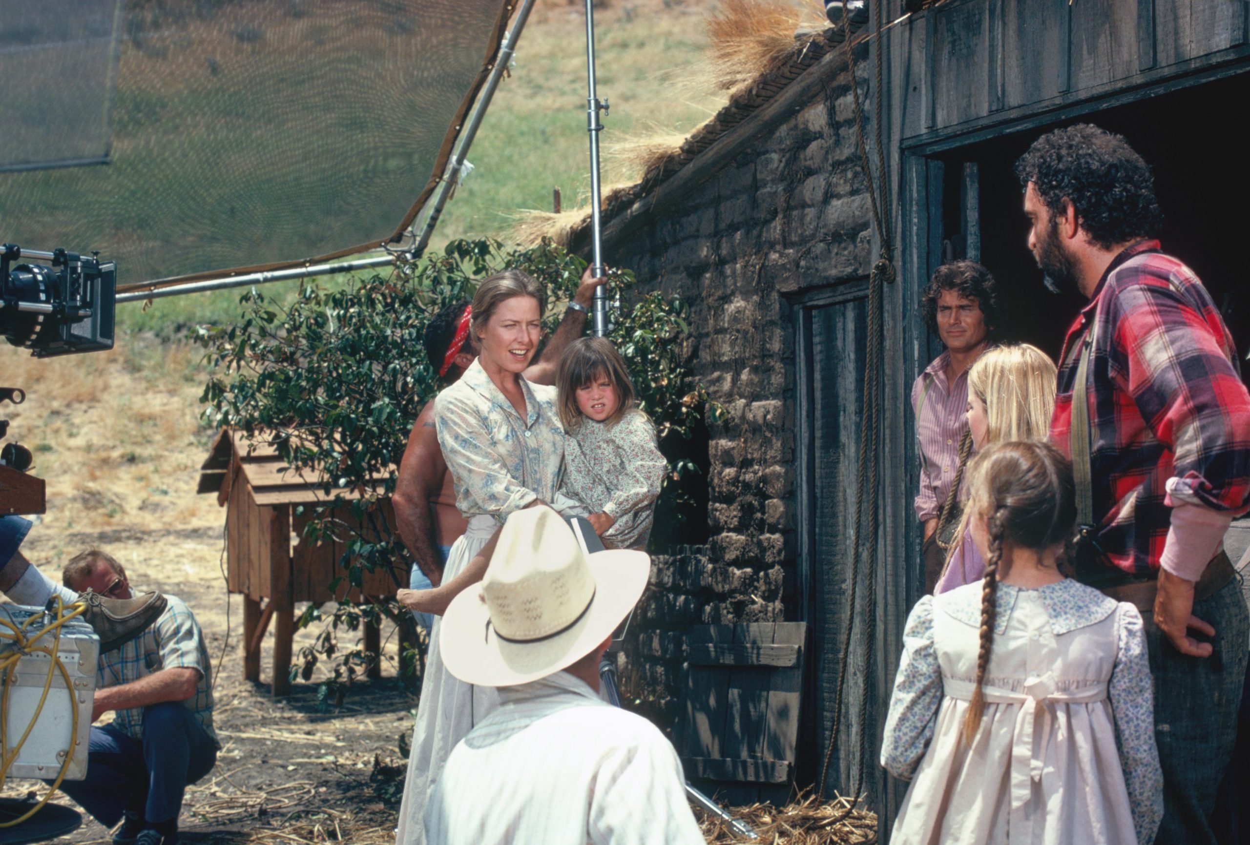 Karen Grassle, Michael Landon, and the Little House on the Prairie cast during a scene.