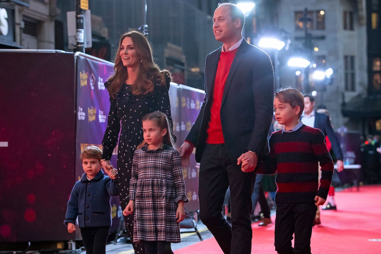 Kate Middleton and Prince William walking on the red carpet with their three children