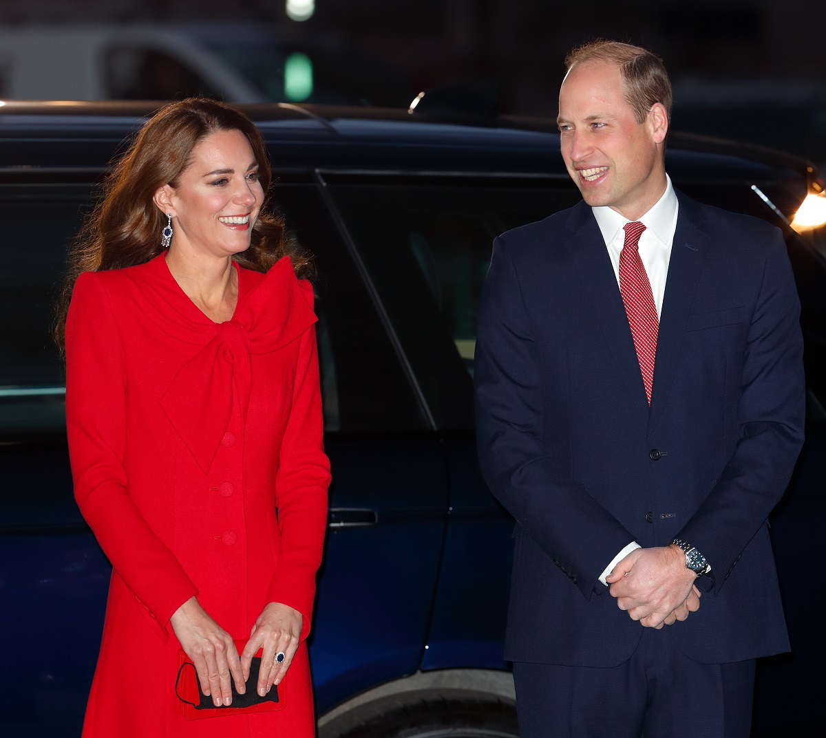 Kate Middleton and Prince William smiling as they arrive at the Together at Christmas community carol service