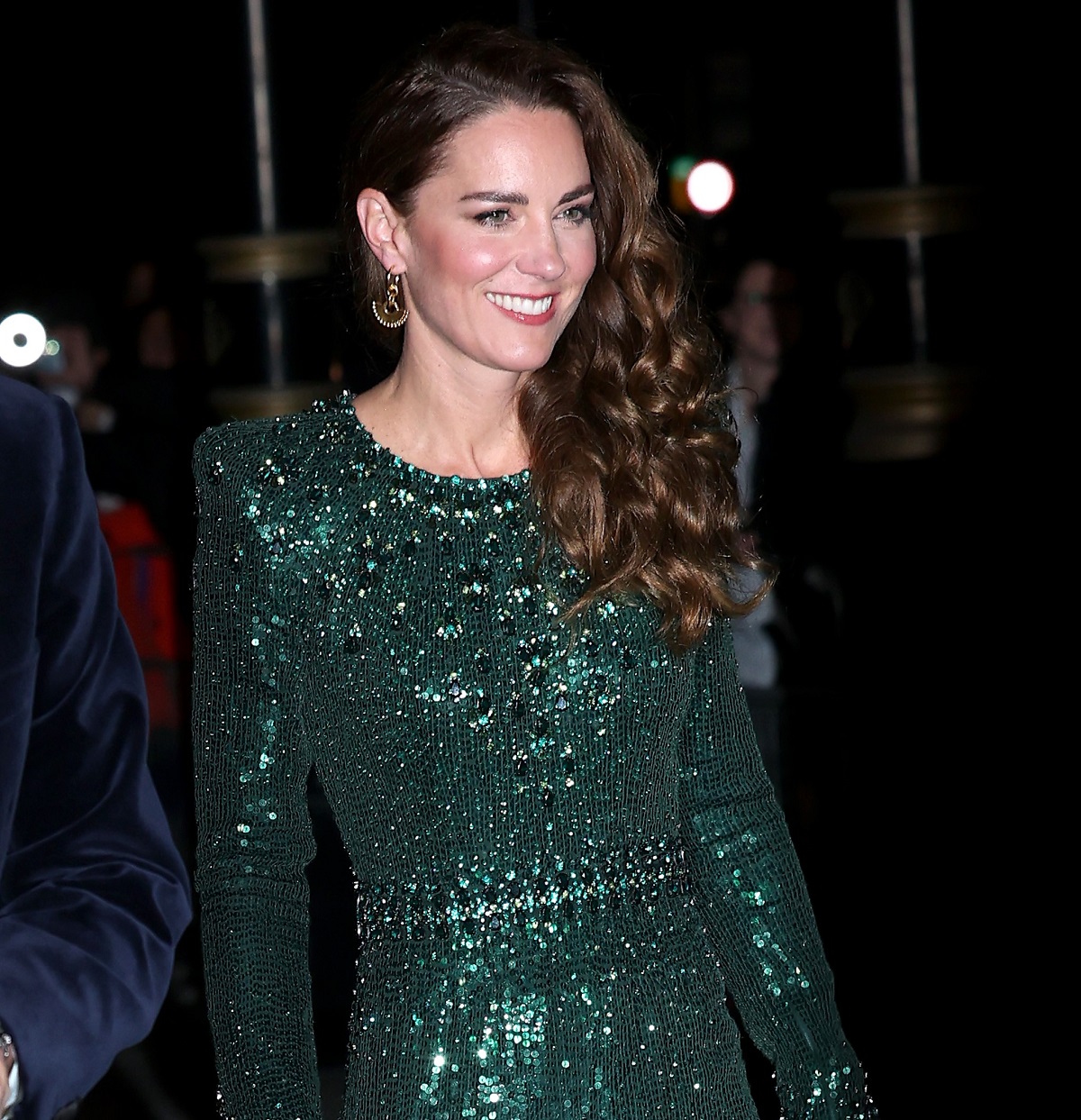 Kate Middleton wearing a sparkling green gown and smiling as she arrives at the Royal Variety Performance