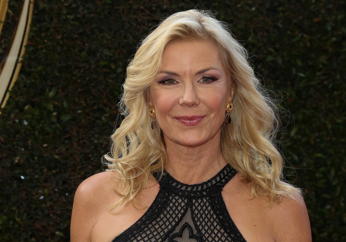 'The Bold and the Beautiful' actor Katherine Kelly Lang wearing a black dress and standing in front of a hedge.