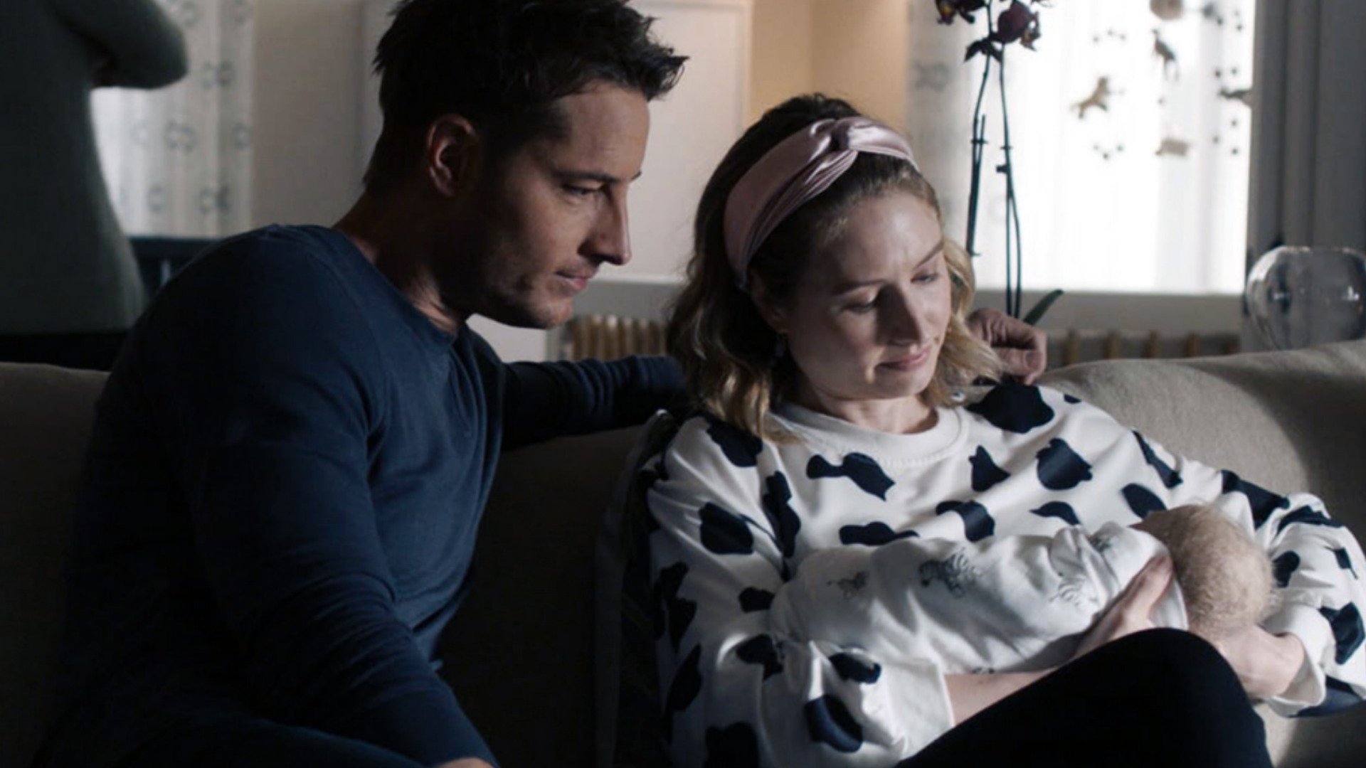 Justin Hartley as Kevin and Caitlin Thompson as Madison sit together and hold their baby in ‘This Is Us’ Season 5