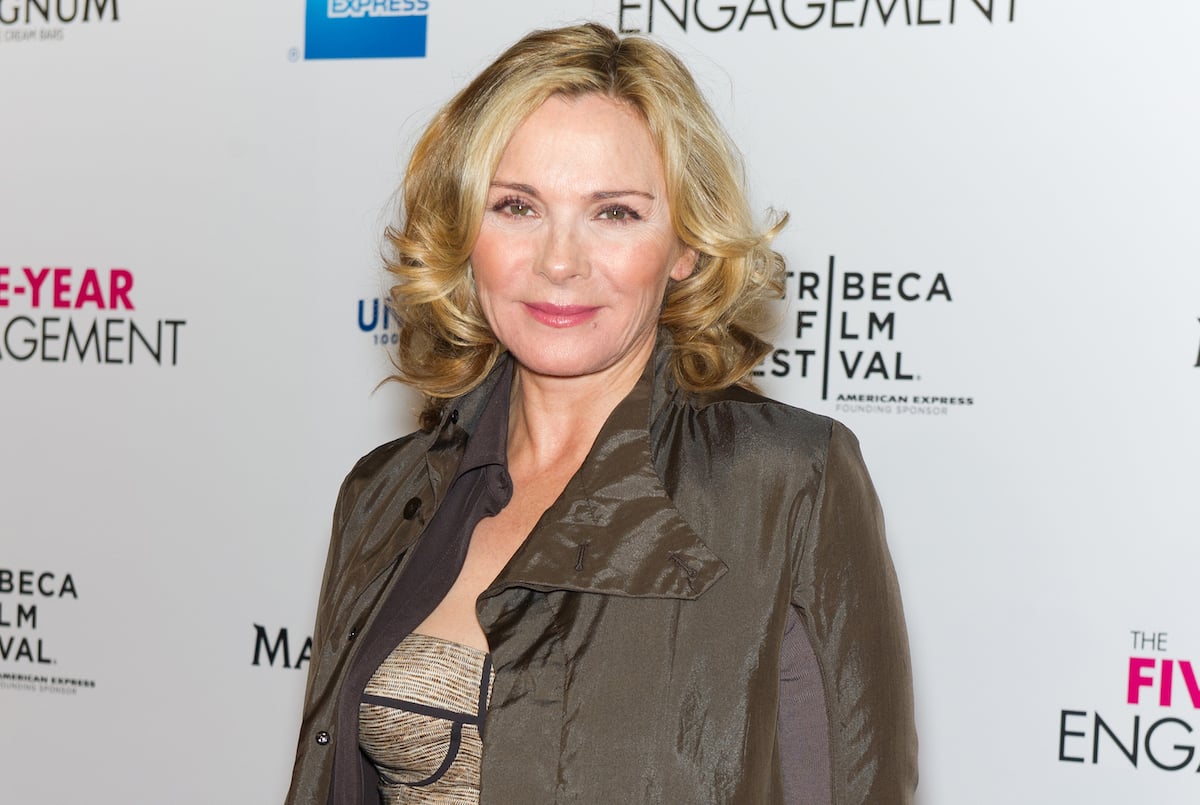 Kim Cattrall smiles for the camera at an event.