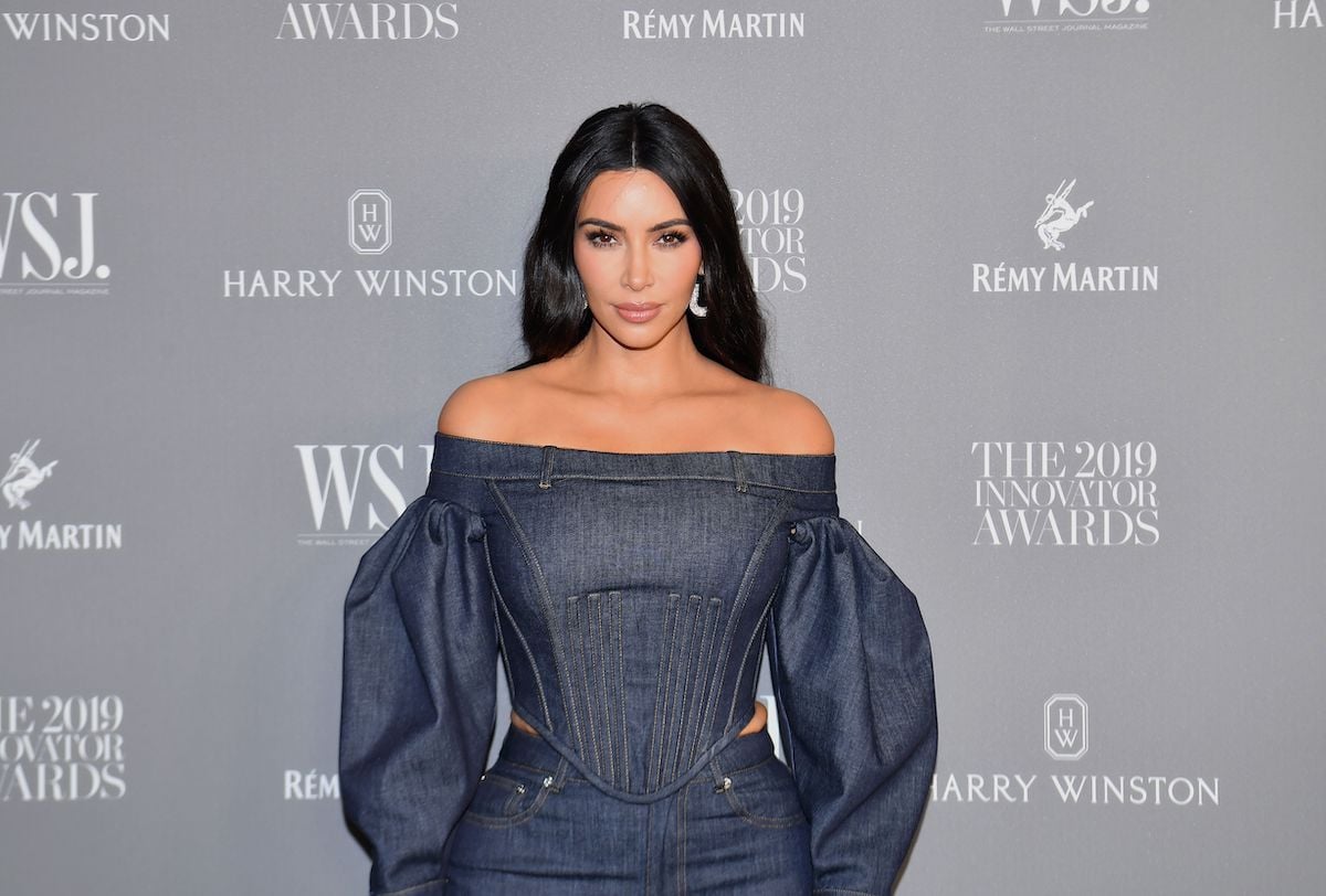 Kim Kardashian West poses in denim at an event.