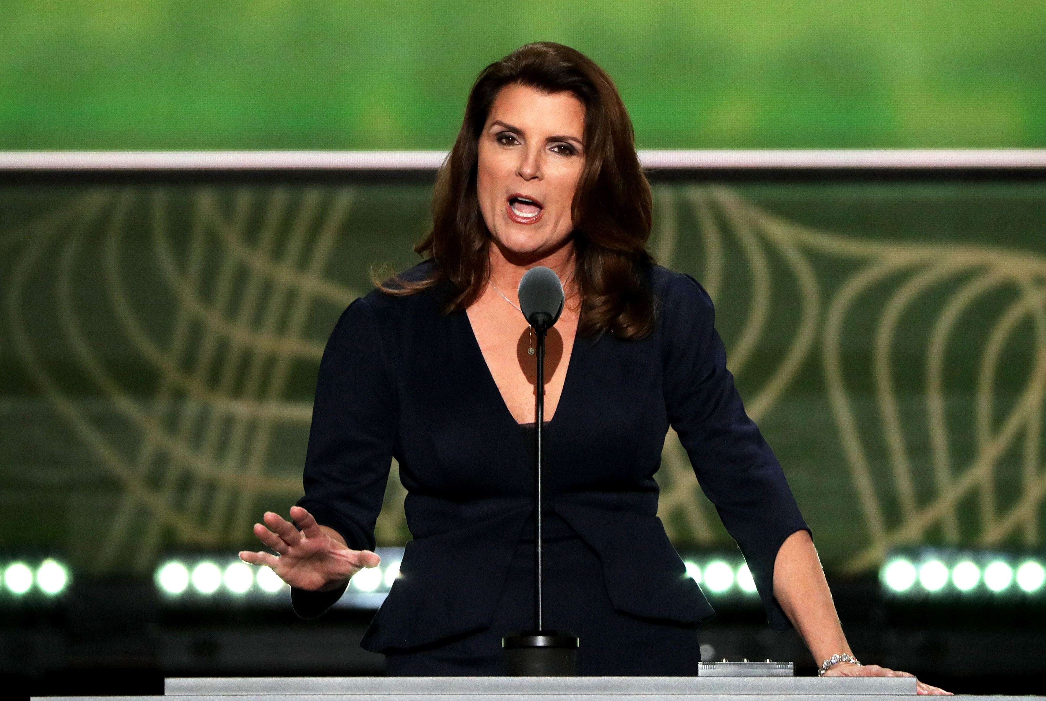 'The Bold and the Beautiful' actor Kimberlin Brown wearing a navy blue dress and speaking into a microphone.