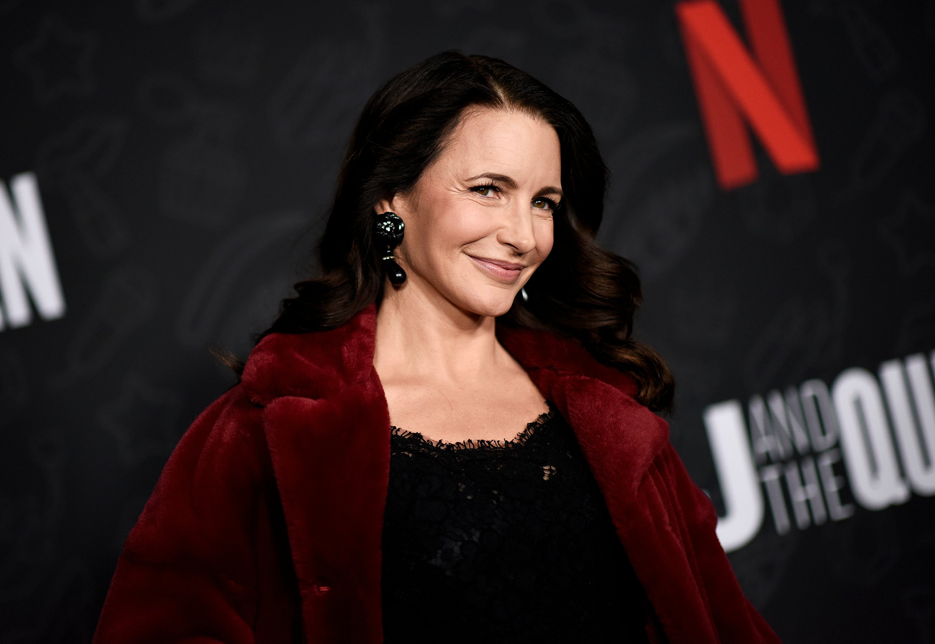 Kristin Davis smiles on the red carpet at 'AJ and the Queen' premiere